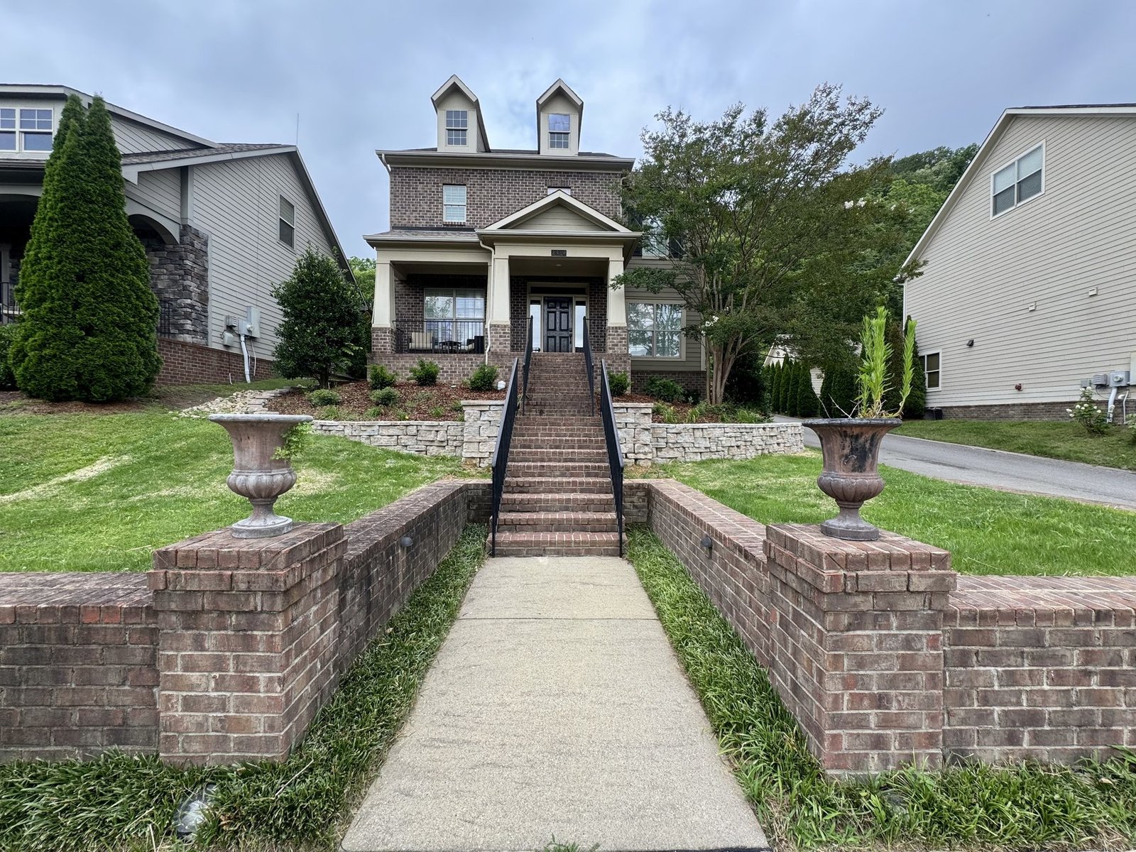 Stone walkway and terraced garden leading to a Nashville home